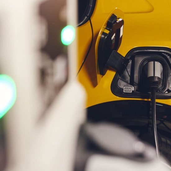Electric car charging in underground car park in mall