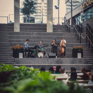 Outdoor jazz performance at The Well Toronto Jazz Night with live band playing for the crowd in a in the court at The Well.